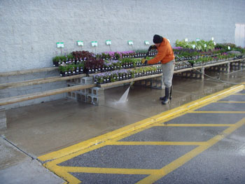Storefront sidewalk being pressure washed