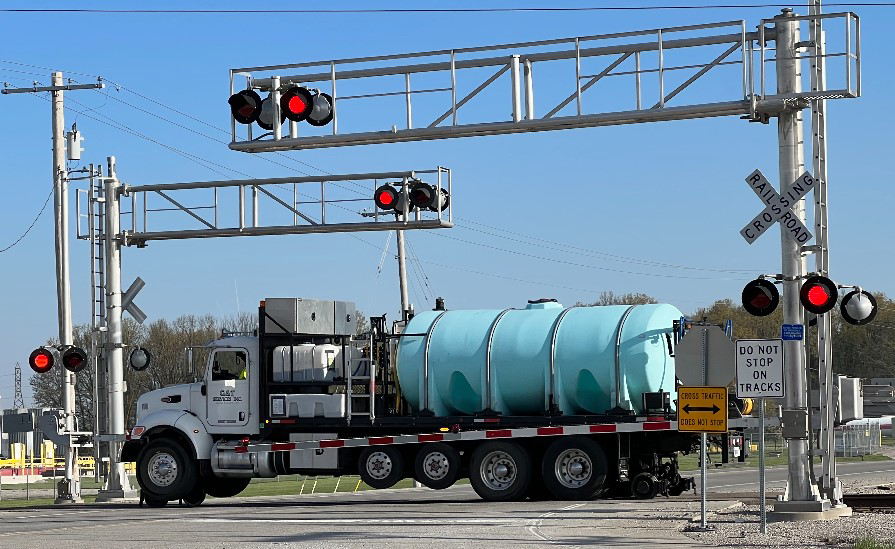 Railroad spraying at crossing